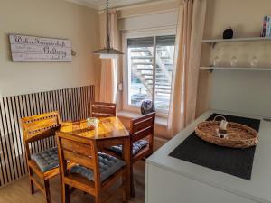 a kitchen with a table and chairs and a dining room at Ferienwohnung Seerose mit Terrasse in Sassnitz
