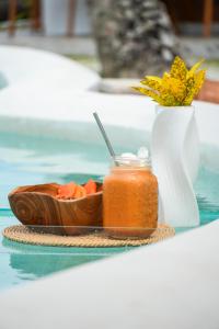 a bowl of fruit and a jar of sauce on a table at Ombara Resort Mentawai in Katiet