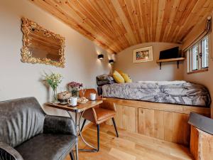 a bedroom with a bed and a table in a room at 1 Bed in Welshpool oc-92796 in Welshpool