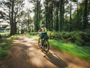 a person riding a bike down a dirt road at 1 Bed in Welshpool oc-92796 in Welshpool
