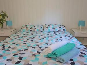 a bedroom with a bed with towels on it at Cas Bufador in Sa Coma