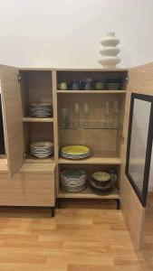 a cabinet filled with plates and glasses and dishes at Sea & Mountain Views Benicassim in Benicàssim