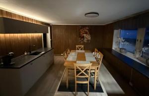 a kitchen with a wooden table and a dining room at Holiday Suite in Bugøynes +12 photos