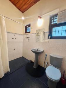 a bathroom with a toilet and a sink at Lovely Home in Panadura +44 photos