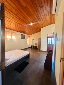 a bedroom with a bed and a wooden ceiling at Lovely Home in Panadura