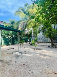 a park with palm trees and a building at Lovely Home in Panadura