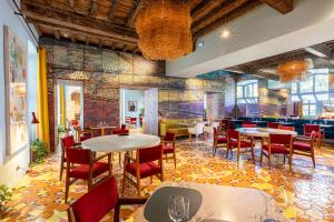 a restaurant with tables and chairs and colorful tiles at L'Arlatan in Arles