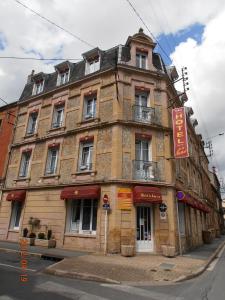 an old building on the corner of a street at Hôtel de la Meuse in Charleville-Mézières