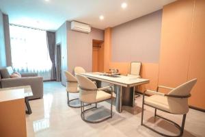 a room with a table and chairs and a couch at VELIN Pattaya Hotel-Central Pattaya-3 in Pattaya +41 photos