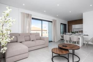 a living room with a couch and a table at Serena By Marenssa in Moncarapacho