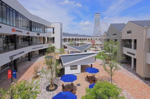 an overhead view of a building with blue umbrellas at KIX Nest in Izumi-Sano