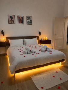 a bedroom with a bed with red roses on it at Villa La Torre in San Giuliano Terme