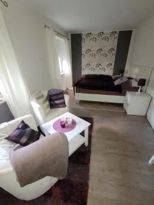 a living room with a couch and a table at Haus Sonnengarten in Brokstedt
