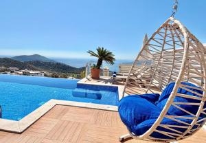 a swing sitting next to a swimming pool at Villa La Mer in Kalkan