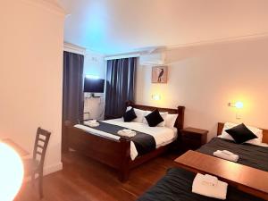 a hotel room with two beds and a table at Coonalpyn Hotel in Coonalpyn
