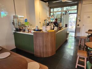 a restaurant with a counter with people preparing food at Old City Hall, Contactless Check In in Bangkok