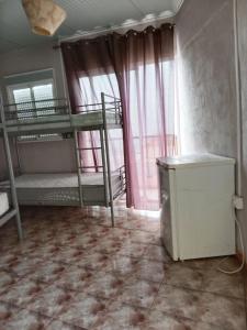 a room with two bunk beds and a window at Tenerife Hostel in Los Cristianos +5 photos