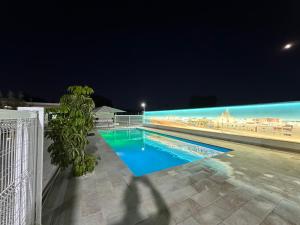 a view of a swimming pool at night at Serenity Beach Pinar in Chipiona
