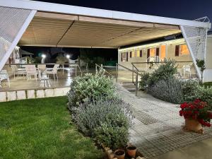 a patio with a table and chairs and plants at Serenity Beach Pinar in Chipiona