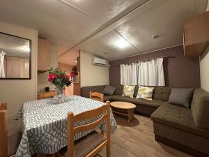 a living room with a table and a couch at Serenity Beach Pinar in Chipiona
