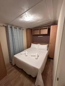 a bedroom with a bed with two towels on it at Serenity Beach Pinar in Chipiona