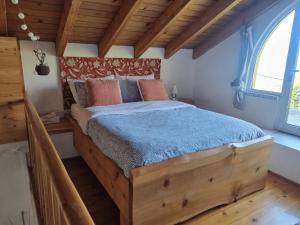 a bedroom with a large wooden bed in a room at Sunset Nest in Ponta Delgada