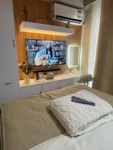 a bedroom with a bed with a tv on the wall at AAvista in Basbas +21 photos