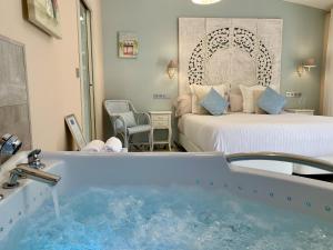 a hotel room with a tub and a bed at Akla Hotel Palacio Torre de Ruesga in Gibaja