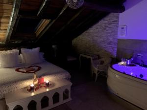 a bedroom with a bed and a tub with candles at Akla Hotel Palacio Torre de Ruesga in Gibaja +30 photos