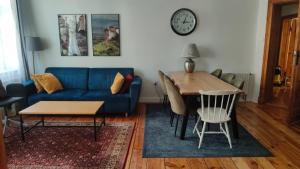 a living room with a blue couch and a table at Prad 543 in Poznań