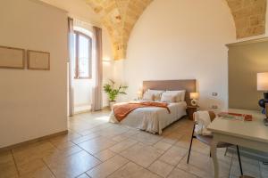 a bedroom with a bed and a table in a room at Mediterranea Residence in Nardò +82 photos