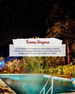 a sign that says tennessee vogendas with a swimming pool at Cabañas Alto del Bosque in Coñaripe
