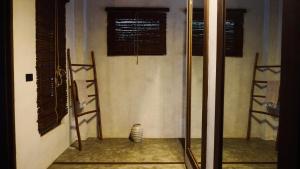 a room with two windows and a glass door at Cala Tuason Villas in General Luna