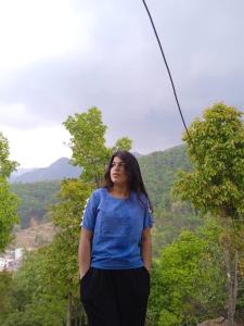 a woman is standing on a zip line at Bagchandi resort in Kathmandu