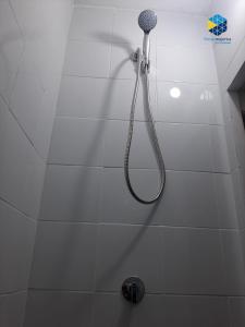 a shower with a shower head in a bathroom at Cas Bufador in Sa Coma +20 photos
