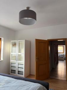 a bedroom with a bed and a light at Ferienwohnung Sensbachtal in Untersensbach