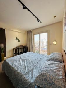 a bedroom with a bed and a large window at Unique Studio Free access beach in Hurghada +30 photos