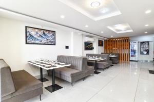 a dining room with tables and chairs in a restaurant at FabHotel The Backyard Bowl in Indore +35 photos