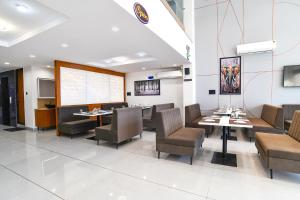 a dining room with a table and chairs and a screen at FabHotel The Backyard Bowl in Indore
