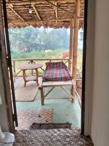a porch with a bench and a picnic table at Banana garden in Pai +17 photos