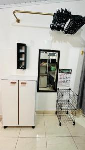 a kitchen with a counter and a mirror at Kitnet com ar-condicionado e entrada privativa SC in Itajaí