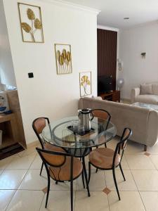 a living room with a glass table and chairs at Lamar Villas 2 in Tengahgirang