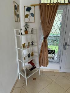 a white shelf in a room with a window at Lamar Villas 2 in Tengahgirang