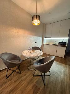 a dining room with a table and two chairs at Solis apart otel in Batumi