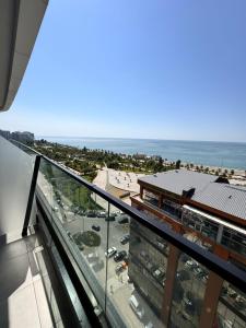 a view of the ocean from the balcony of a building at Solis apart otel in Batumi