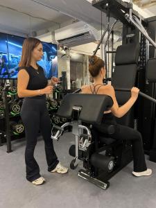 a woman talking to a woman in a gym at Anjeliq Downtown Boutique Hotel in Alanya