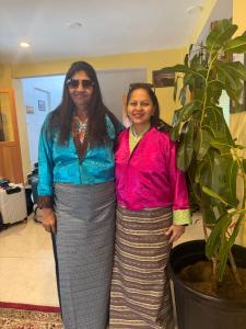 two women standing next to a potted plant at Taktshang Paradise in Paro +15 photos