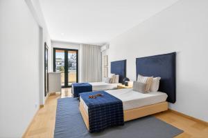 a hotel room with two beds and a couch at Aquamar Pro 116 in Quarteira +38 photos