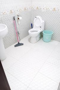 a bathroom with a toilet and a sink at Hotel Red Roof & Restaurant in Abbottabad +43 photos