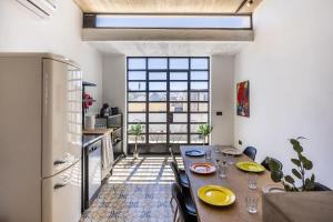 a dining room with a table and a kitchen at Birkirkara Typical 2BDR Townhouse in Birkirkara +13 photos